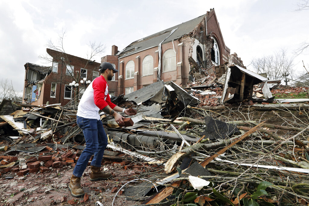 Sumant Joshi helps to clean up rubble at the East End United Methodist Church