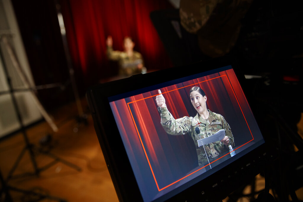 U.S. Army Field Band member Staff Sgt. Sarah Polinski, originally of Sayre, Pa., is seen on a monitor as she gives the thumbs up during the rehearsal of their daily "We Stand Ready" virtual concert series