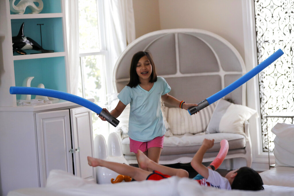 Juliet Daly, 12, plays with her brother Dominic, 5, in their family home 