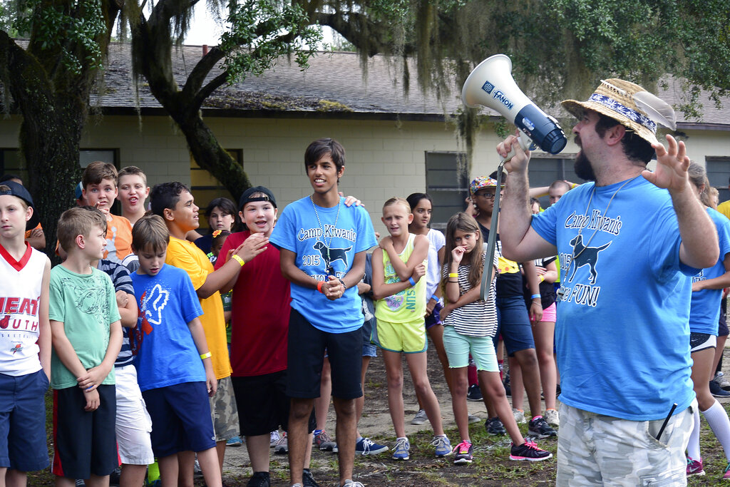 Camp Kiwanis, games instructor John Griffin, right, shouts directions through a megaphone as campers look on at Camp Kiwanis in the Ocala National Forest near Ocala, Fla. Camp Kiwanis will not open this summer for the first time in 72 years due to concerns about spread of the novel coronavirus.