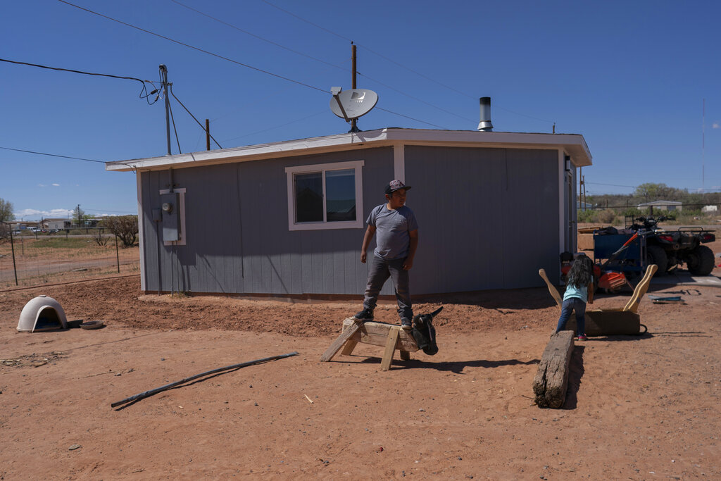 A boy and his sister play in their family compound in Tuba City, Ariz.