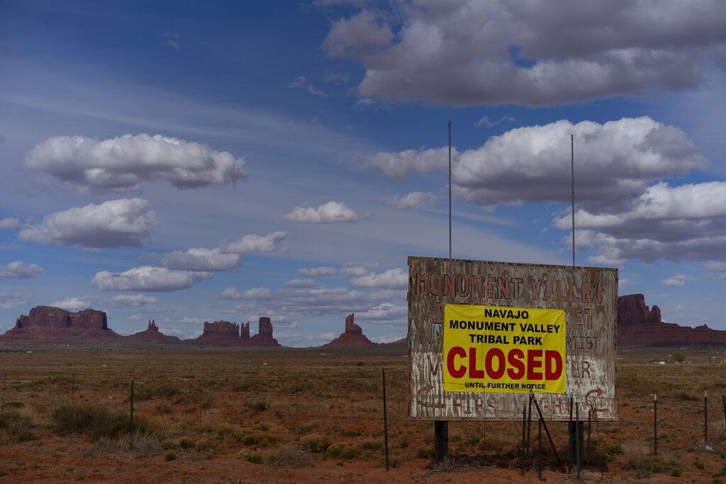 A sign reads "Navajo Monument Vally Tribal Park Closed Until Further Notice" posted at the entrance of Monument Valley in Oljato-Monument Valley, Utah