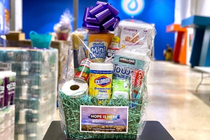 Basket of items including toilet paper, bleach wipes and breakfast cereal