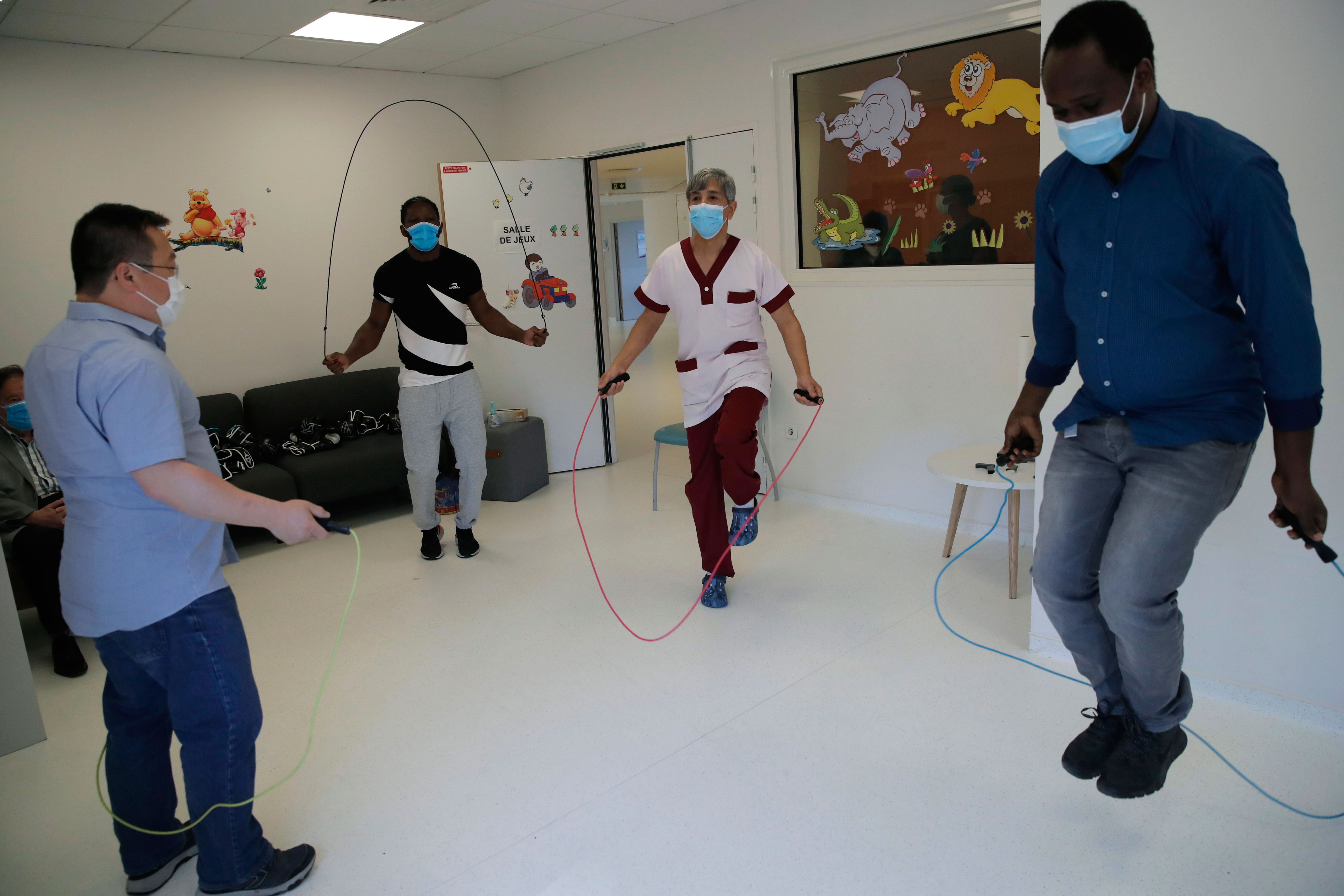 medical staff jump rope as they train with boxer Hassan N’Dam