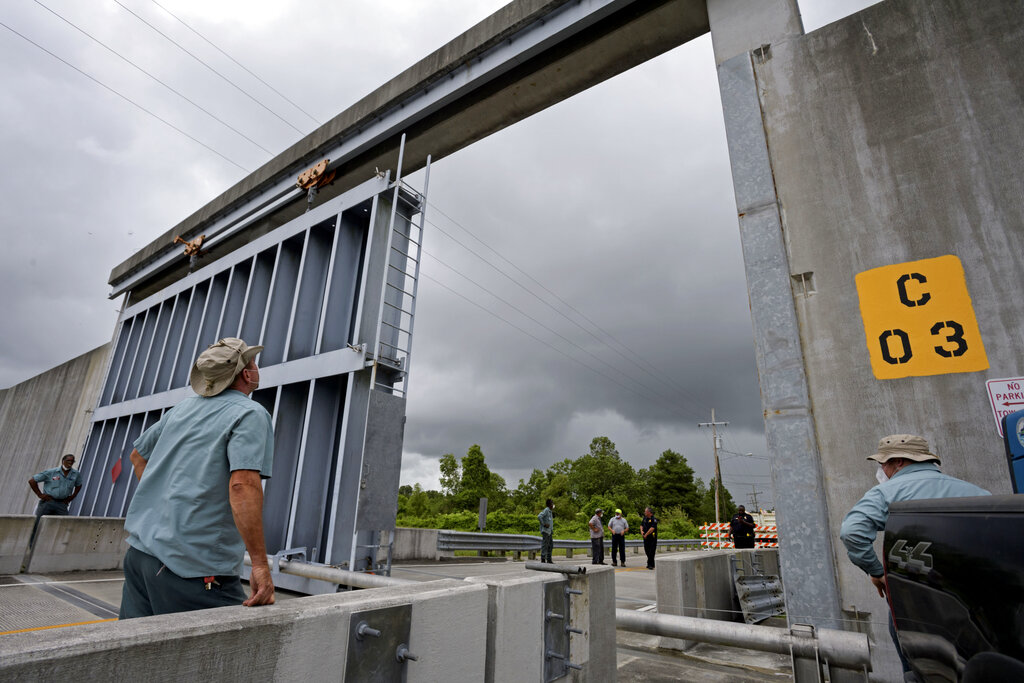 Crews from the Southeast Louisiana Flood Protection Authority East close the Bayou Road flood gate in St. Bernard Parish, La. Saturday, June 6, 2020, ahead of Tropical Storm Cristobal. A re-energized Tropical Storm Cristobal advanced toward the U.S. Gulf Coast early Saturday, bringing with it the heavy rains that already caused flooding and mudslides in Mexico and Central America.