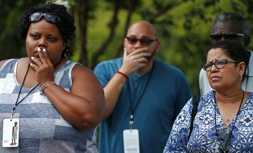 Najula Jackson, of Atlanta, left, and Lance Brown, of New Orleans, listen as a tour guide explains the Wall of Honor, for all of the known enslaved people who lived at the plantation, at the Whitney Plantation in Edgard, La. 