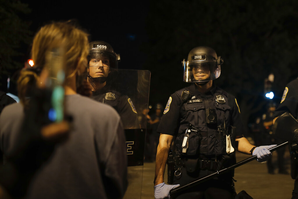 Police form a security line after protesters tried to topple a statue of Andrew Jackson in Lafayette Park