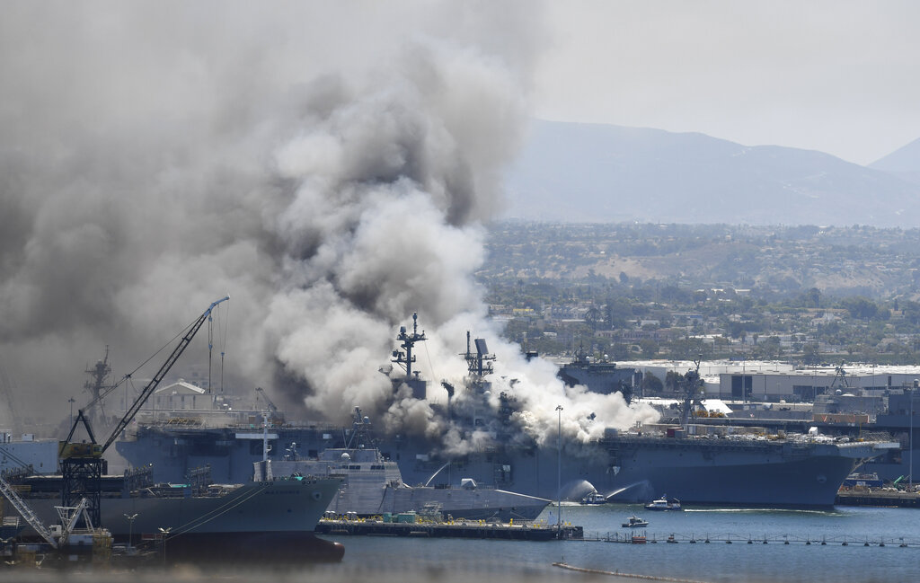 Smoke rises from the USS Bonhomme Richard at Naval Base San Diego