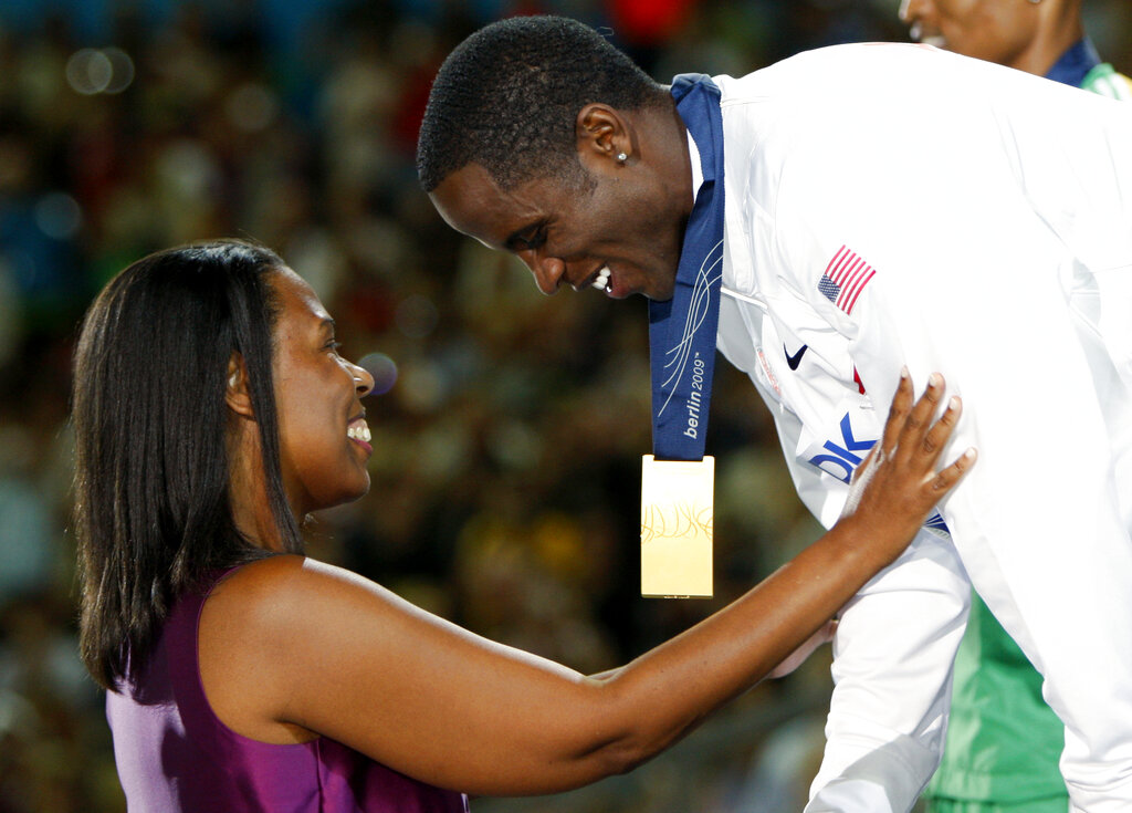 Dwight Phillips, right, receives his gold medal from Jesse Owens