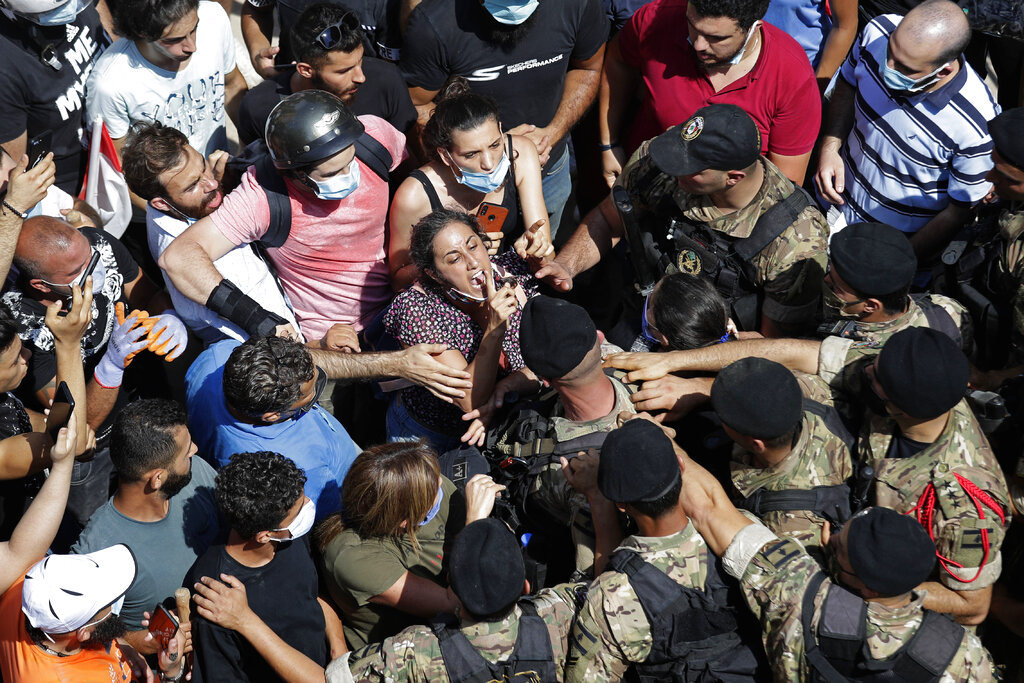 A woman yells at Lebanese soldiers during scuffles with the soldiers who are blocking a road 