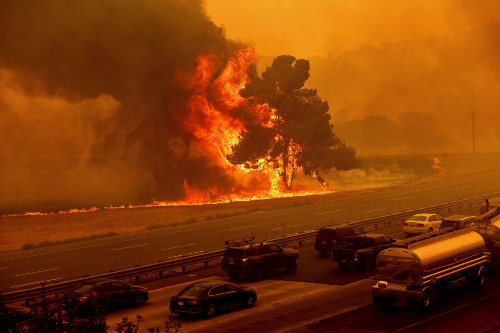 Flames from the LNU Lightning Complex fires jump Interstate 80 in Vacaville, Calif