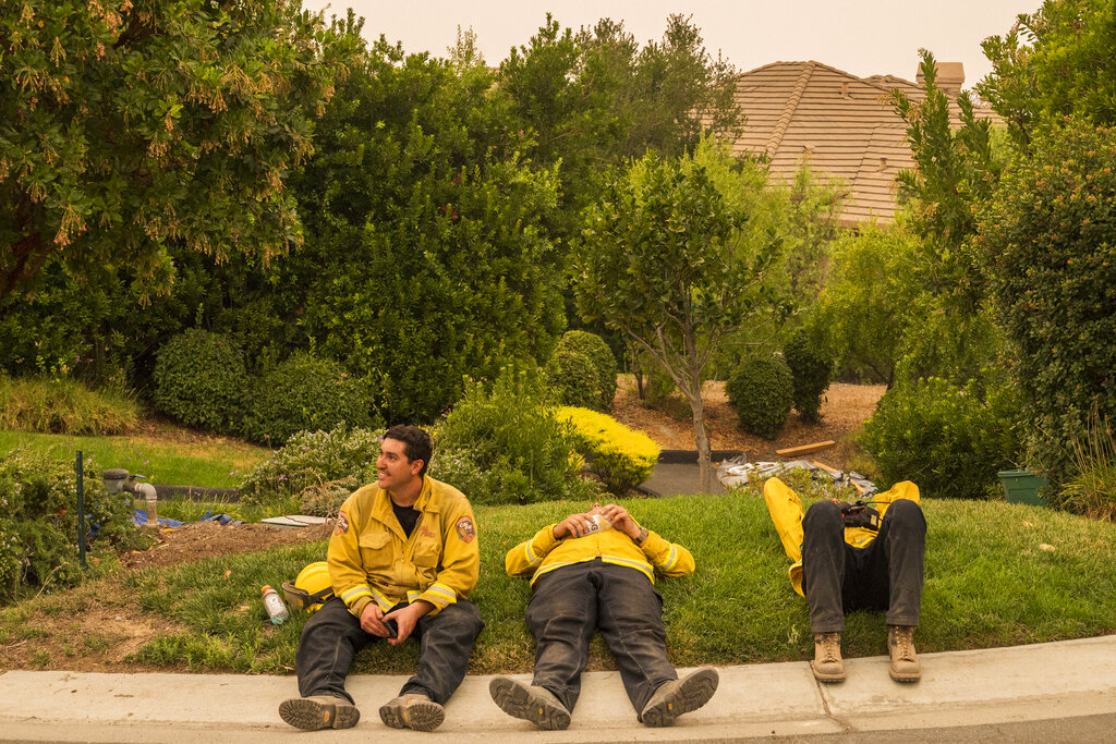 A CalFire crew from Coulterville takes a break while fighting the River Fire near Salinas, Calif.