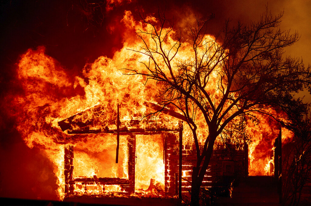 Flames from the LNU Lightning Complex fires consume a home in Vacaville, Calif.