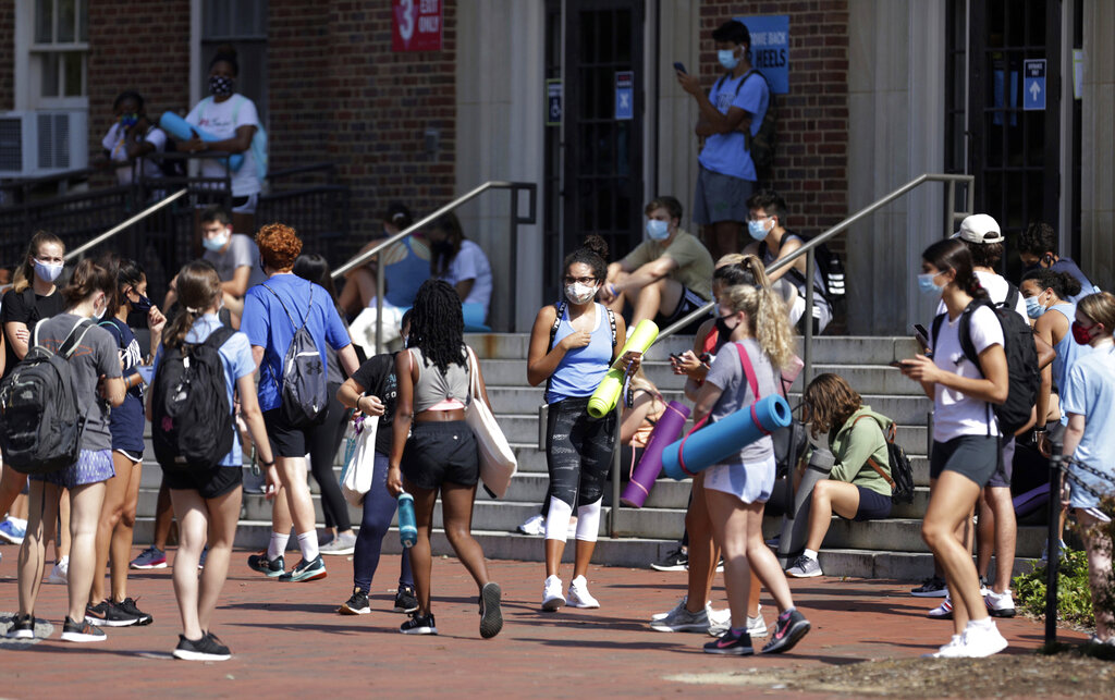 University of North Carolina students wait outside of Woolen Gym on the Chapel Hill, N.C., campus