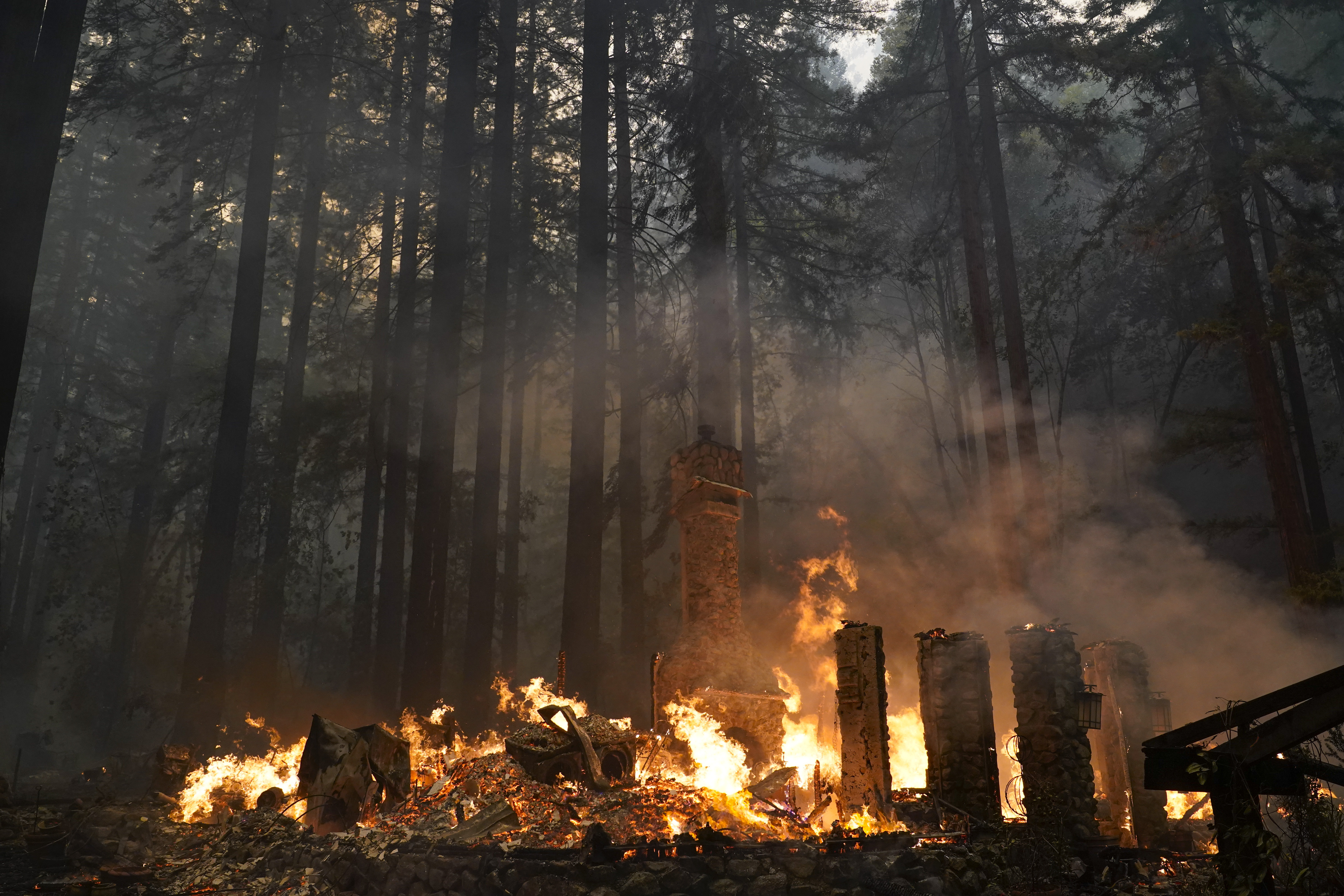 Glendale,CA firefighters hose down hot spots along Empire Grade Rd