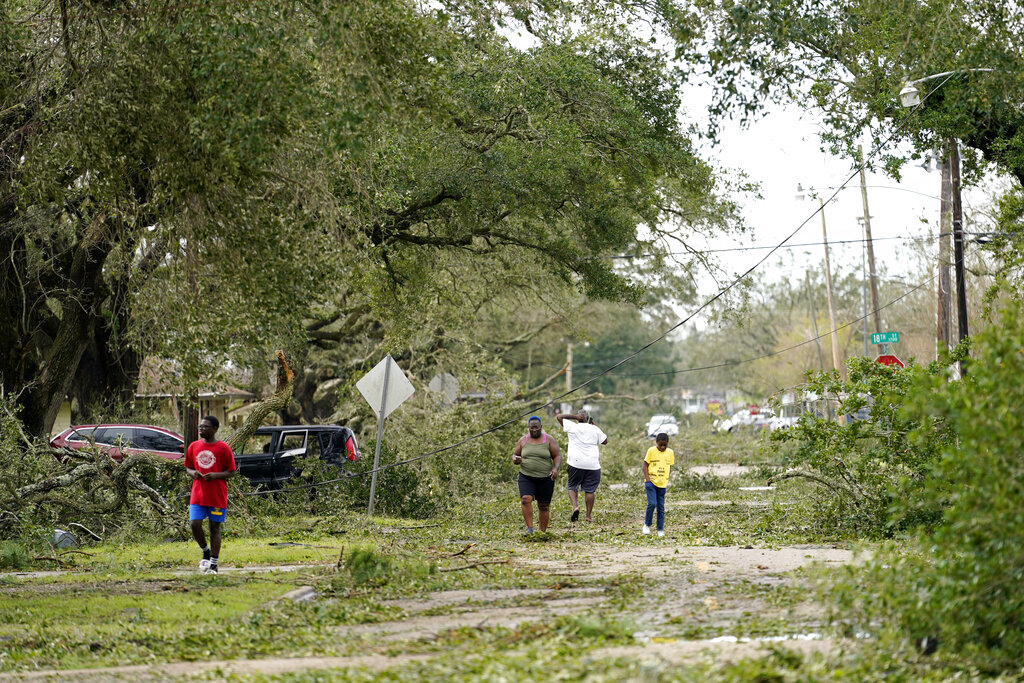 People survey the damage to their neighborhood in Lake Charles, La..