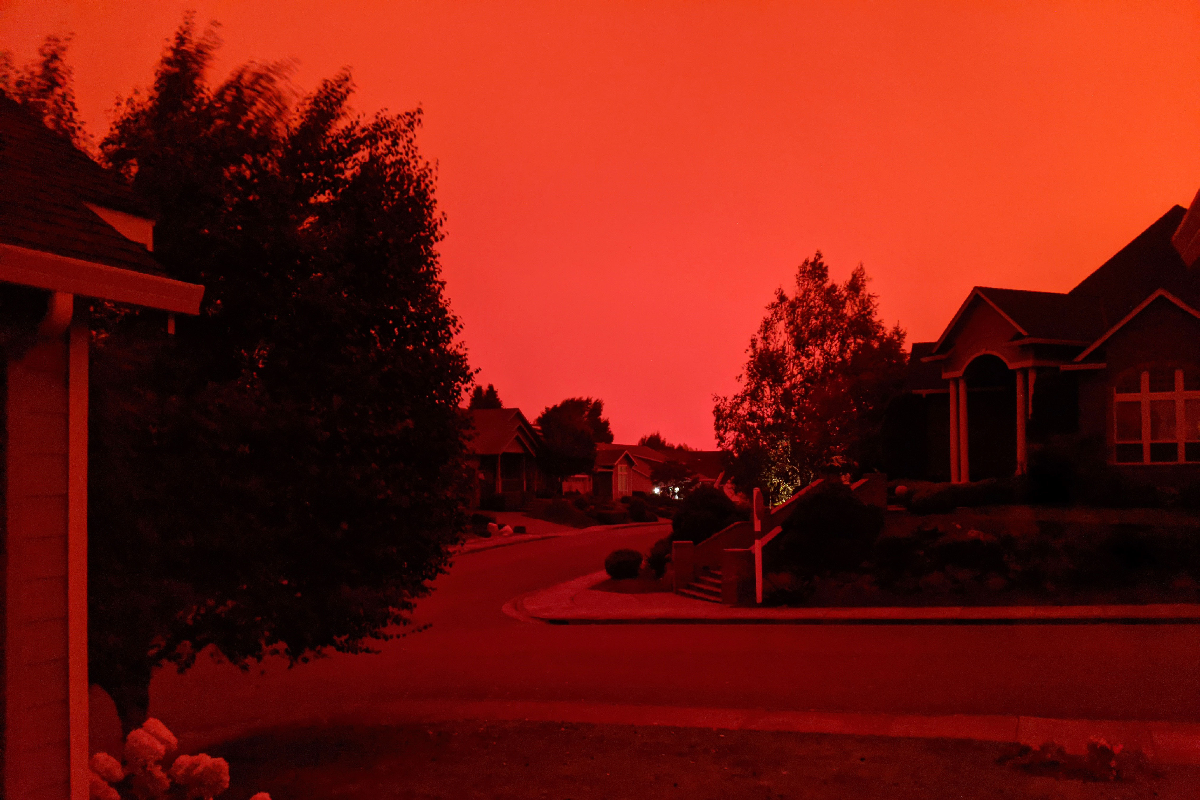 Oregon neighborhood with smoke-darkened sky