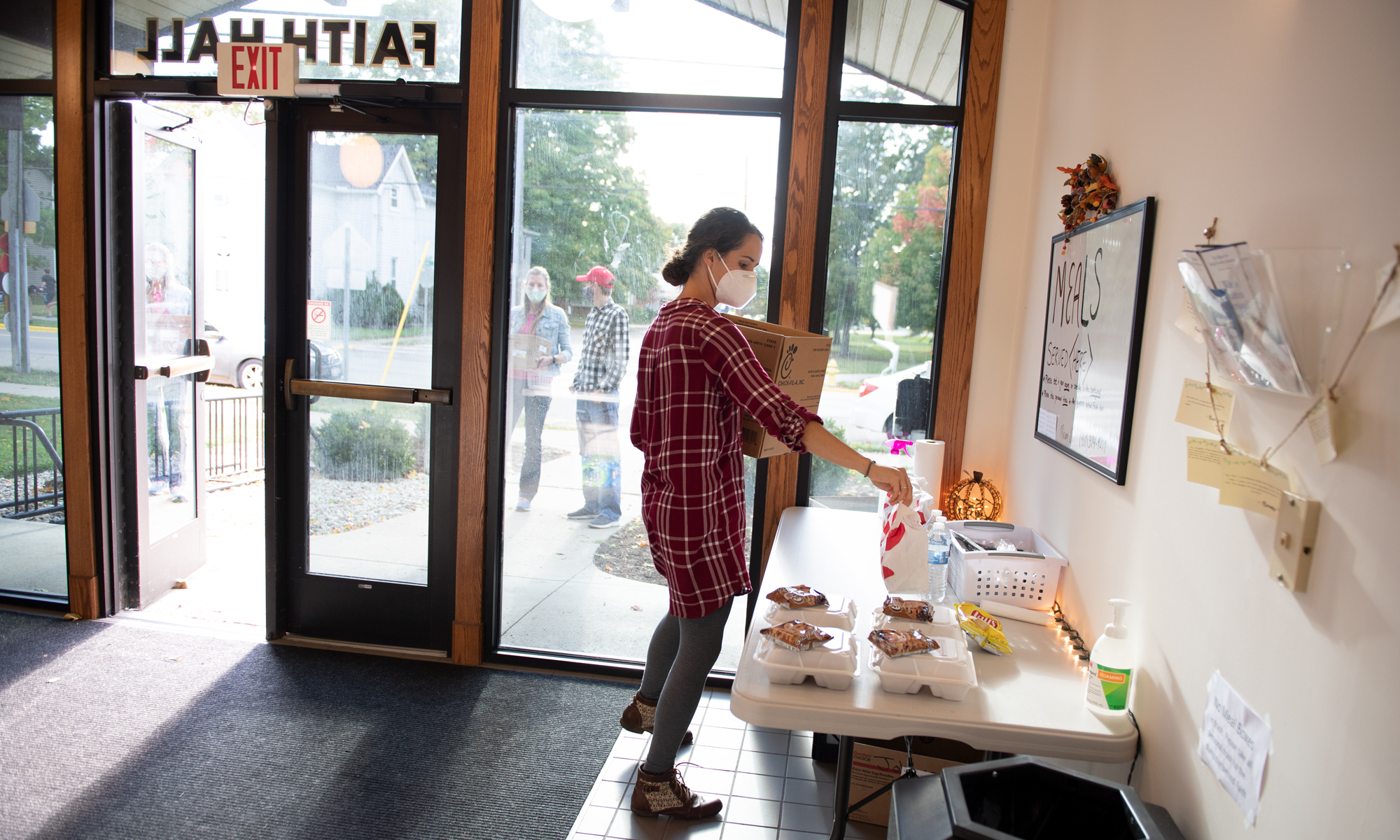 Faith Hall Resident Director Miriam Olar prepares food for students in isolation