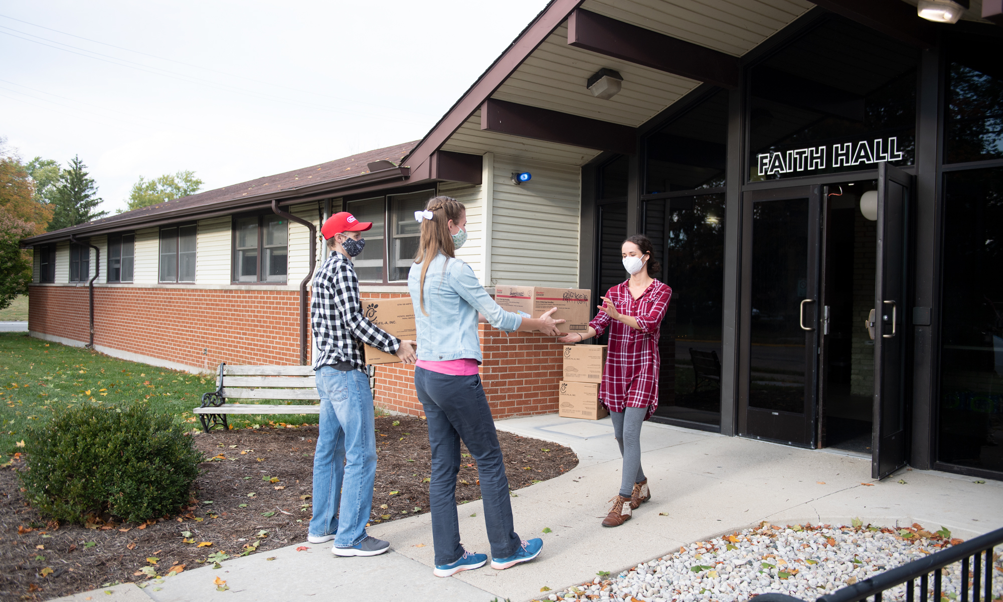 Christie and Jonathan Bitner deliver food to Faith Hall Resident Director Miriam Olar