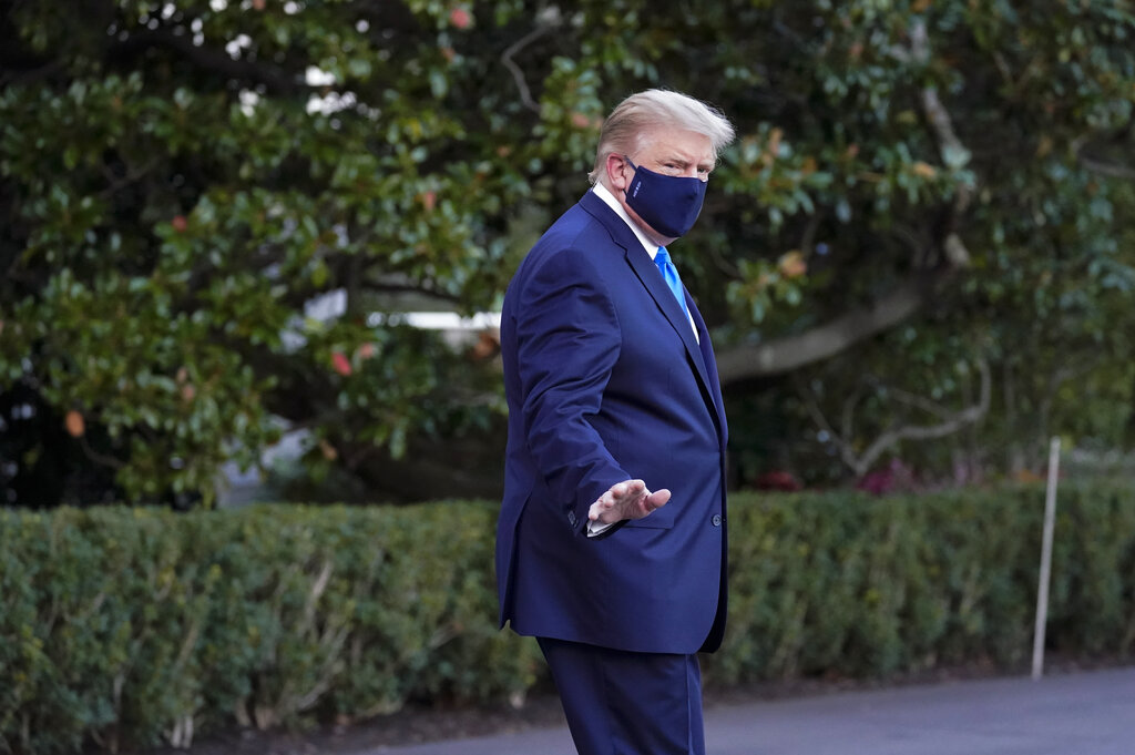 President Donald Trump waves to members of the media as he leaves the White House to go to Walter Reed National Military Medical Center 