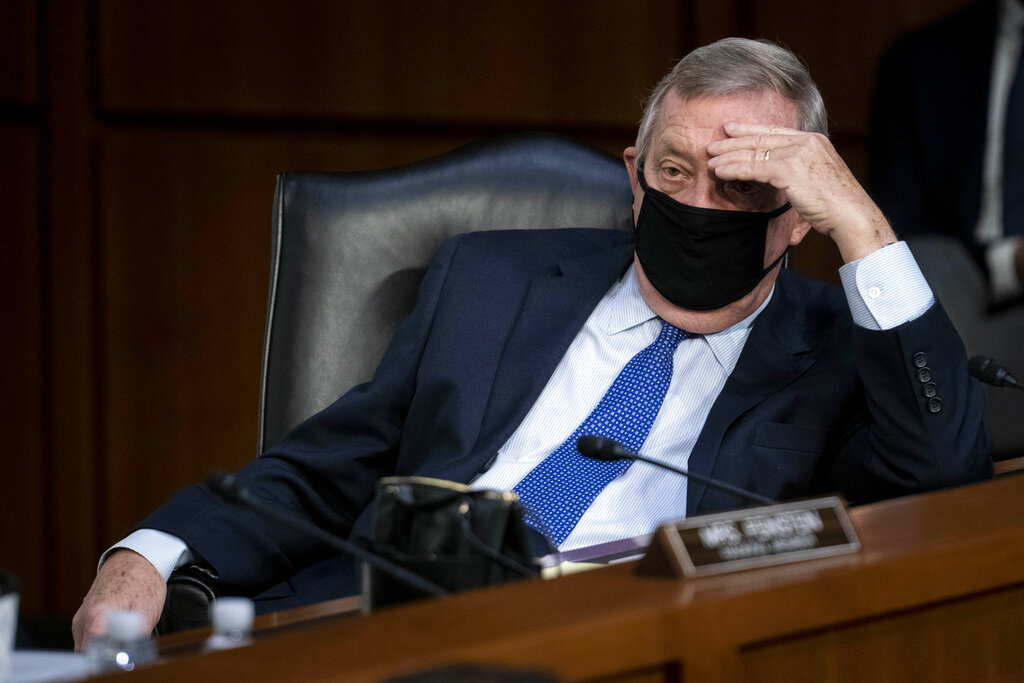 Sen. Dick Durbin, D-Ill., listens as Supreme Court nominee Amy Coney Barrett testifies