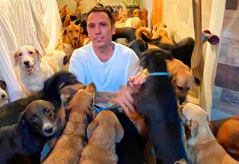 Pimentel plays with dogs that he sheltered at his home in Leona Vicario, Mexico