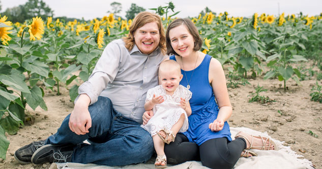Walker family, mom and dad in a sunflower field