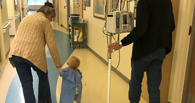 Toddler with grandparents in hospital hallways
