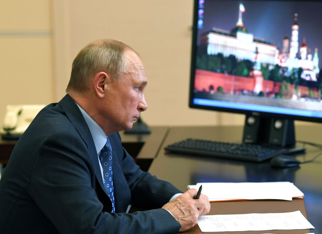 Russian President Vladimir Putin attends a meeting via video conference at the Novo-Ogaryovo residence outside Moscow, Russia