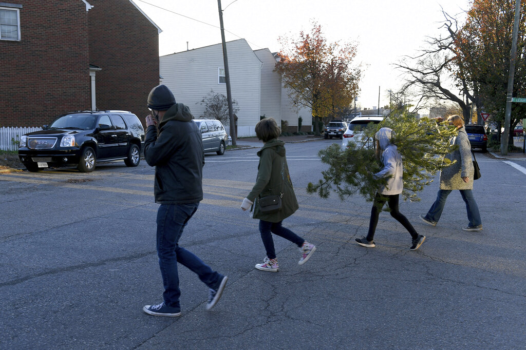 Family taking Charlie Brown Christmas Tree Home