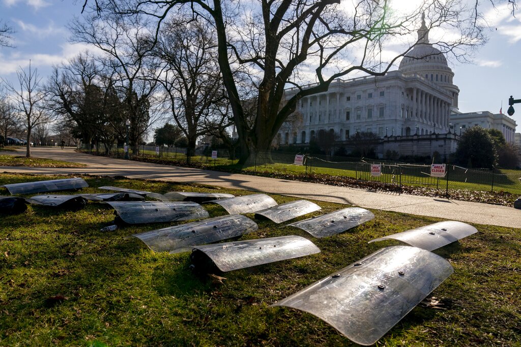 The Dome of the Capitol building is visible as riot gear is laid out on a field on Capitol Hill 