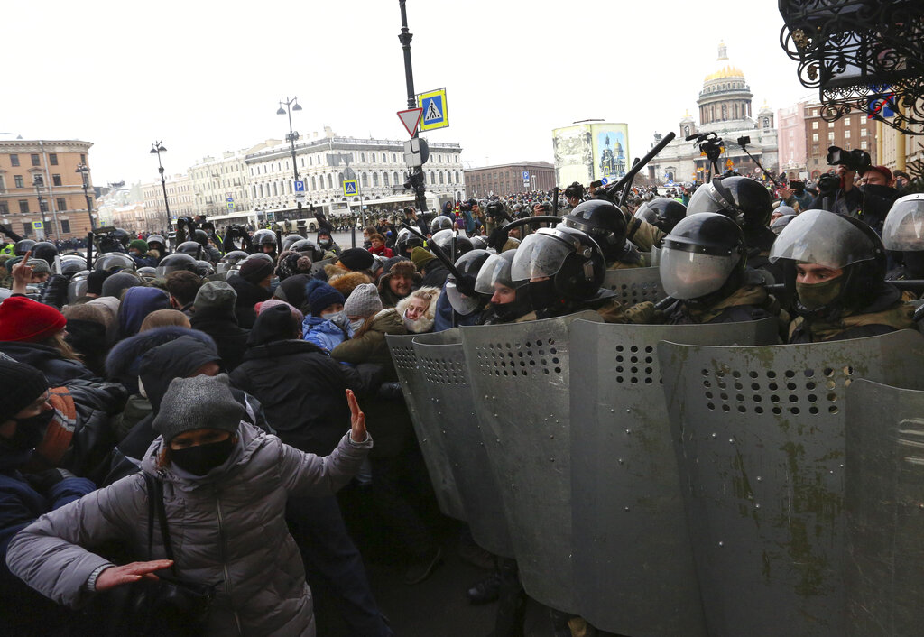 Police stand blocking approaches to the street as protesters try to break through during a protest against the jailing of opposition leader Alexei Navalny in St. Petersburg, Russia