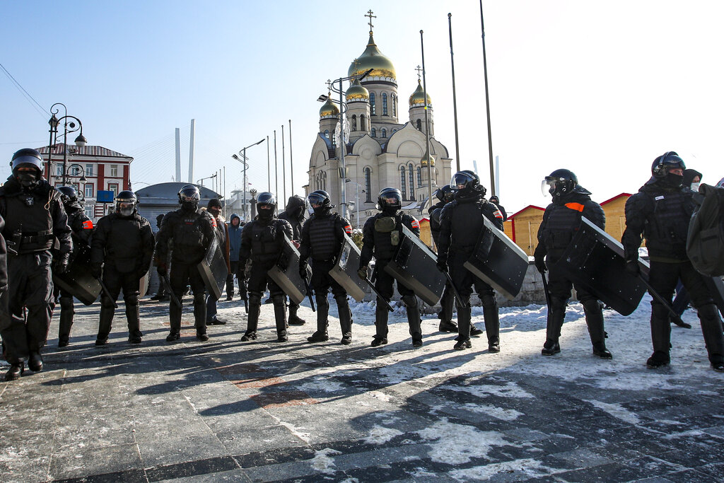 Police officers stand blocking enter to the central square in Vladivostok, Russia