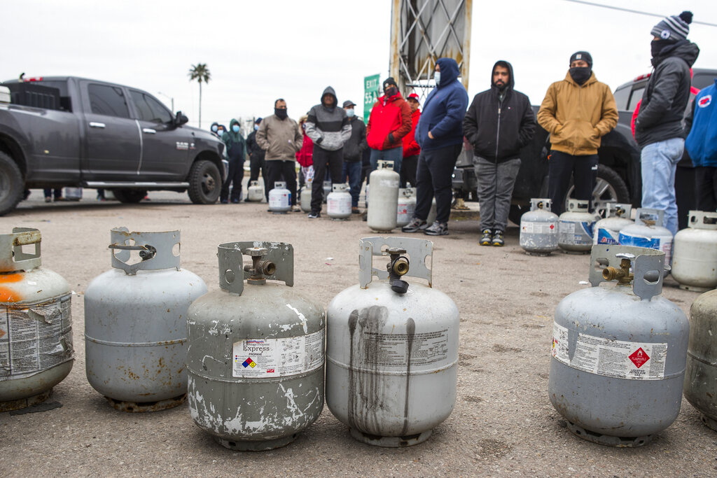 People line up to fill their empty propane tanks in Houston. Temperatures stayed below freezing Tuesday, and many residents were without electricity.