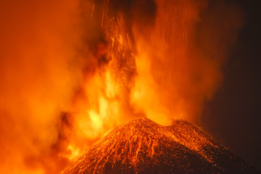 Lava and smoke are belched out from a crater as seen from the north-east side of the Mt Etna volcano near Milo, Sicily