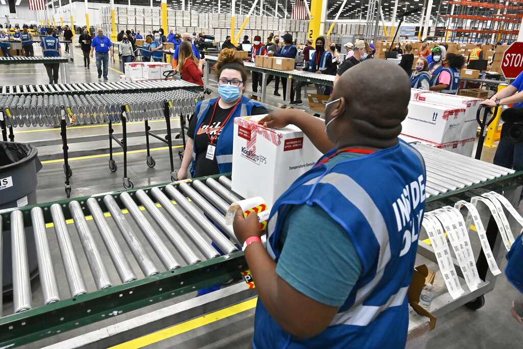First box containing the Johnson & Johnson COVID-19 vaccine heads down the conveyor to an awaiting transport truck at the McKesson facility in Shepherdsville, Ky.
