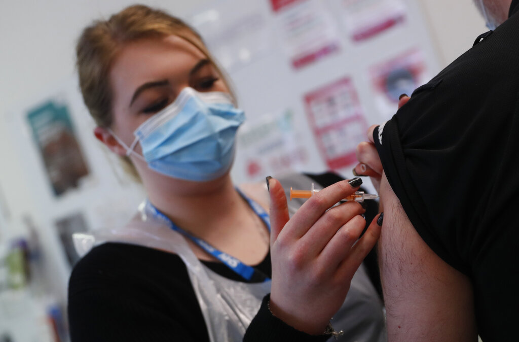 Pharmacy Technician Katrina Bonwick administers a dose of the AstraZeneca COVID-19 vaccine 