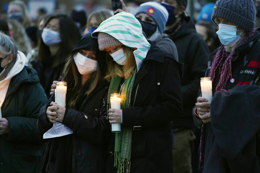 Mourners console each other at vigil for Colorado shooting victims 