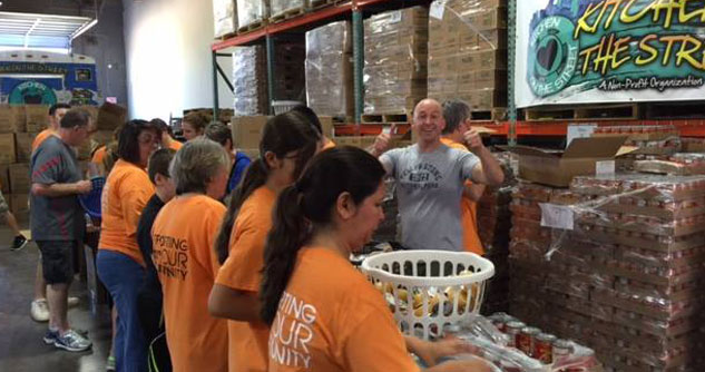 Group of volunteers packing food in a wharehouse