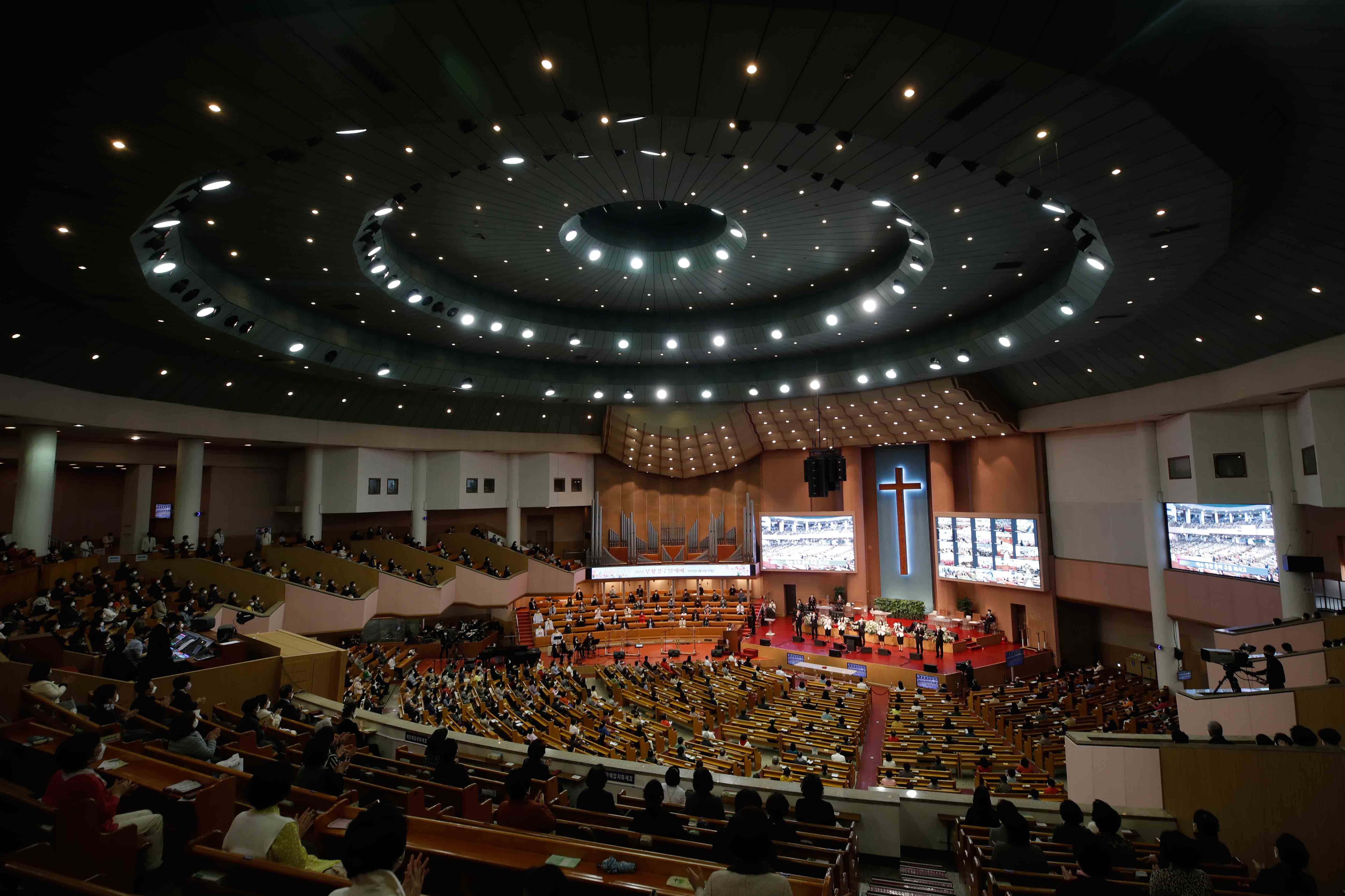 Christians wearing face masks as a precaution against the coronavirus attend while maintaining social distancing during an Easter service at the Yoido Full Gospel Church in Seoul, South Korea, Sunday, April 4, 2021.