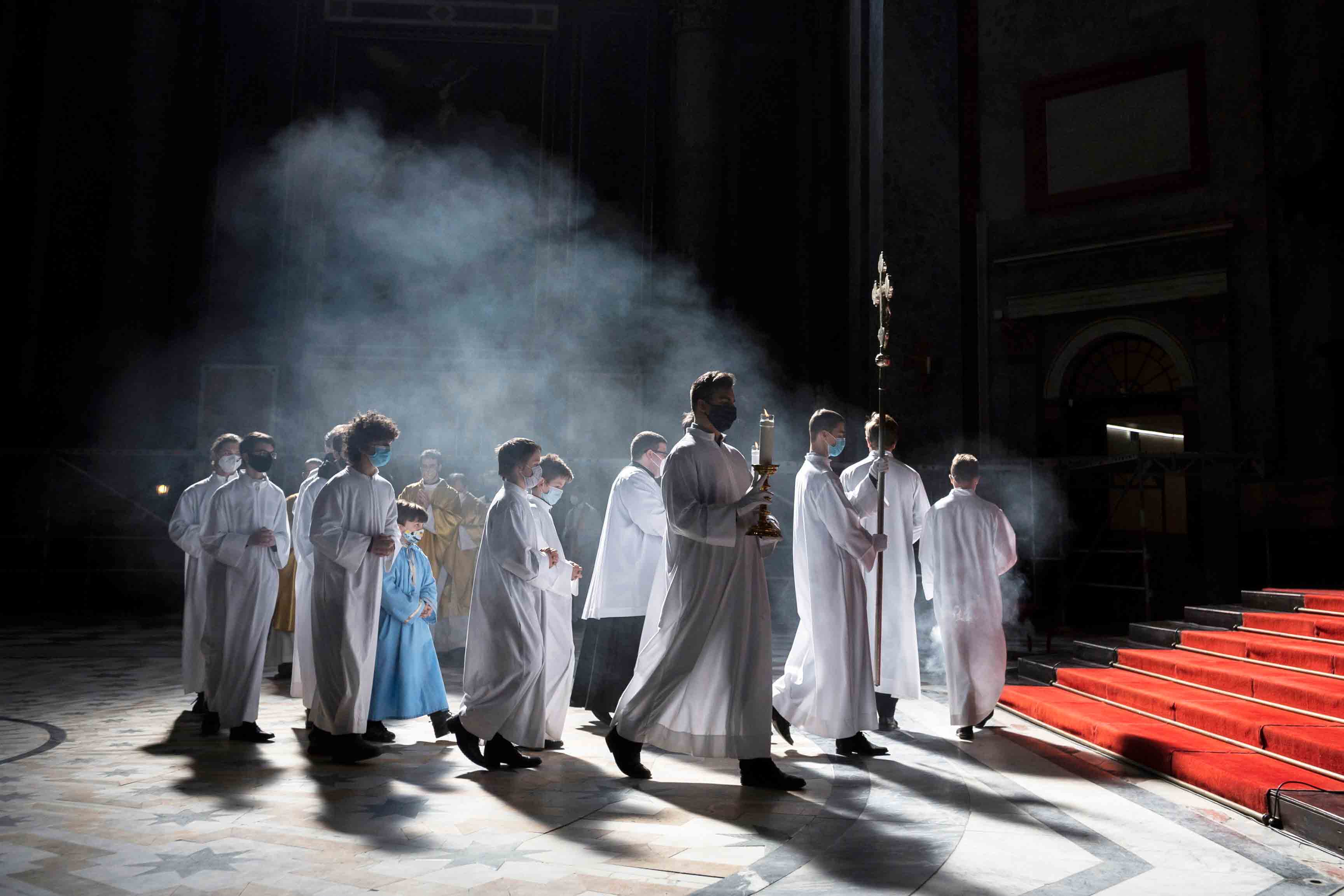 Clergyman and servers arrive for the Easter Sunday Mass celebrated by Primate of the Hungarian Catholic Church, Archbishop of Esztergom-Budapest, Cardinal Peter Erdo in the Esztergom Basilica in the City of Esztergom, Hungary, Sunday, April 4, 2021