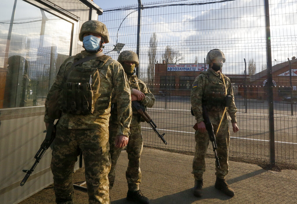 Ukrainian soldiers guard a check point at the town Shshastya, Ukraine