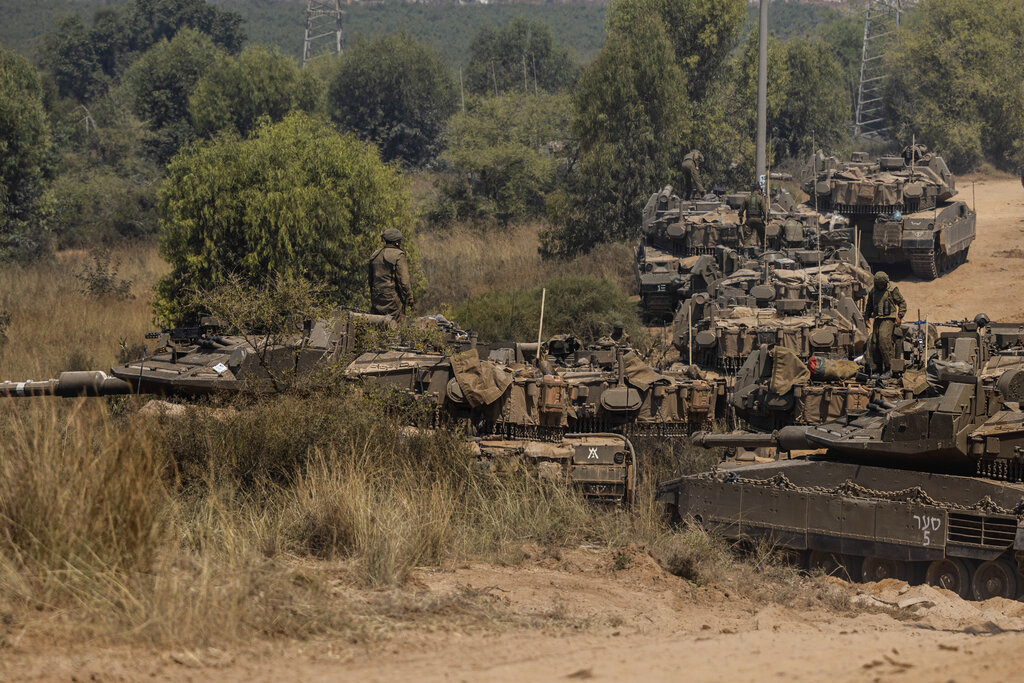 Israeli soldiers with armored vehicles gather in a staging ground near the border with Gaza Strip, southern Israel