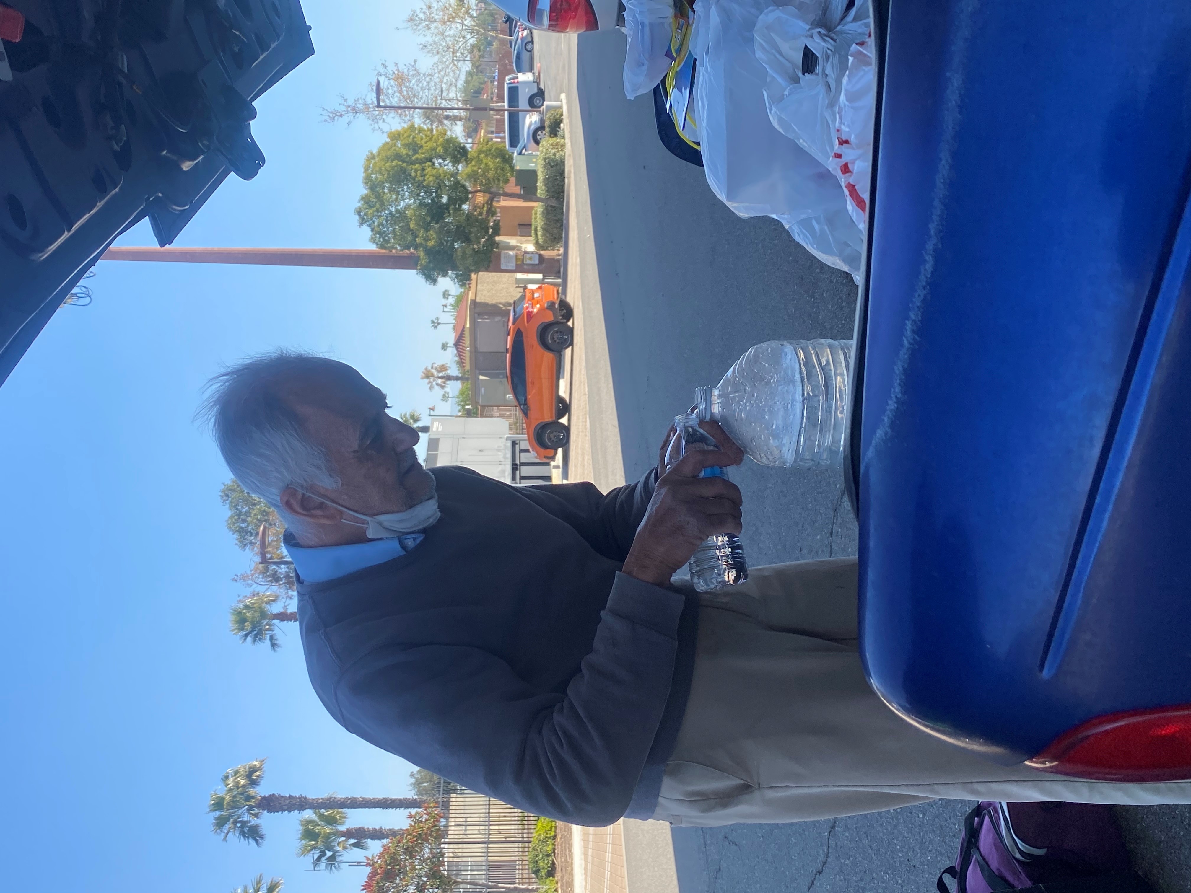 Former Substitute Teacher Mr. V handling water jug in his car