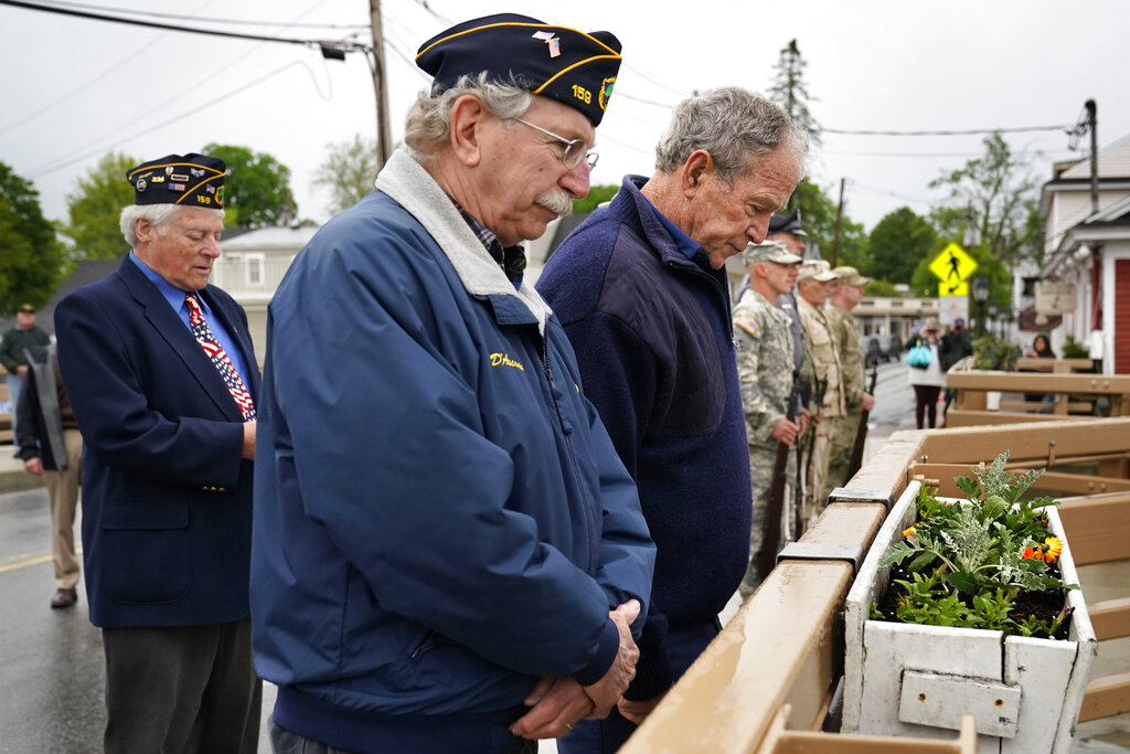 Former President George W. Bush observes a moment of silence during a Memorial Day service