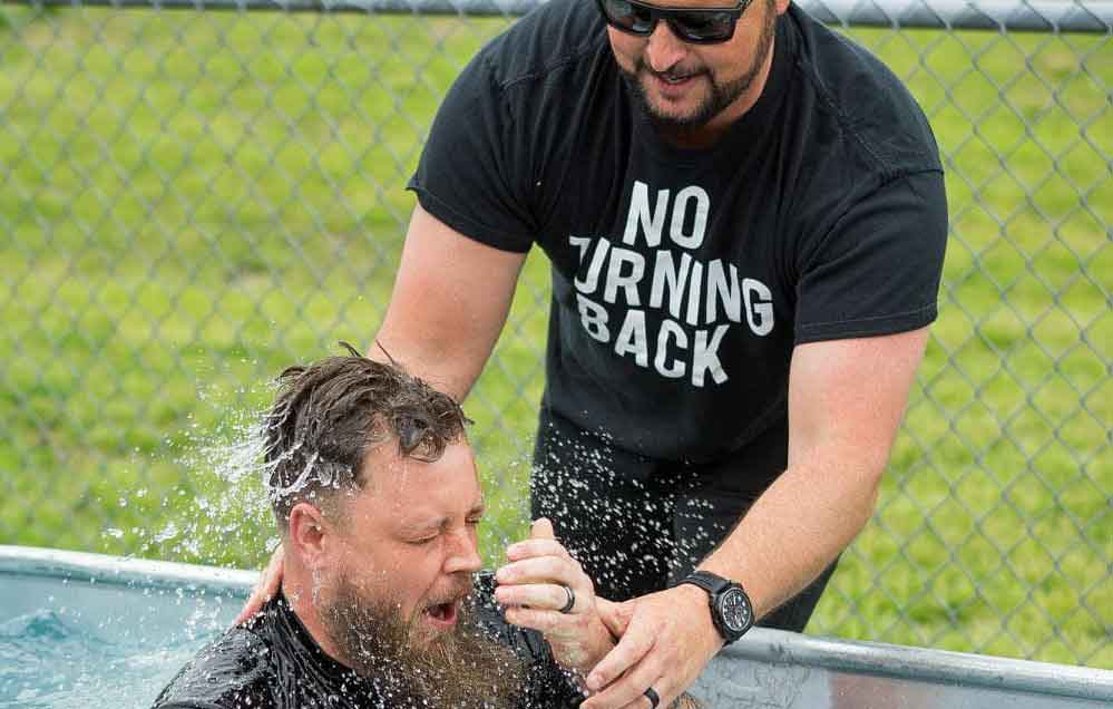 Pastor Jarod conducts outdoor water baptism 