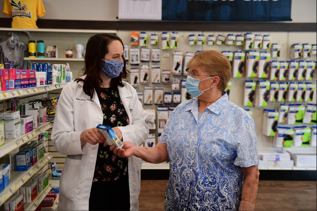 Dr. Katie Perry interacting with customers at Cedar Care Village Pharmacy