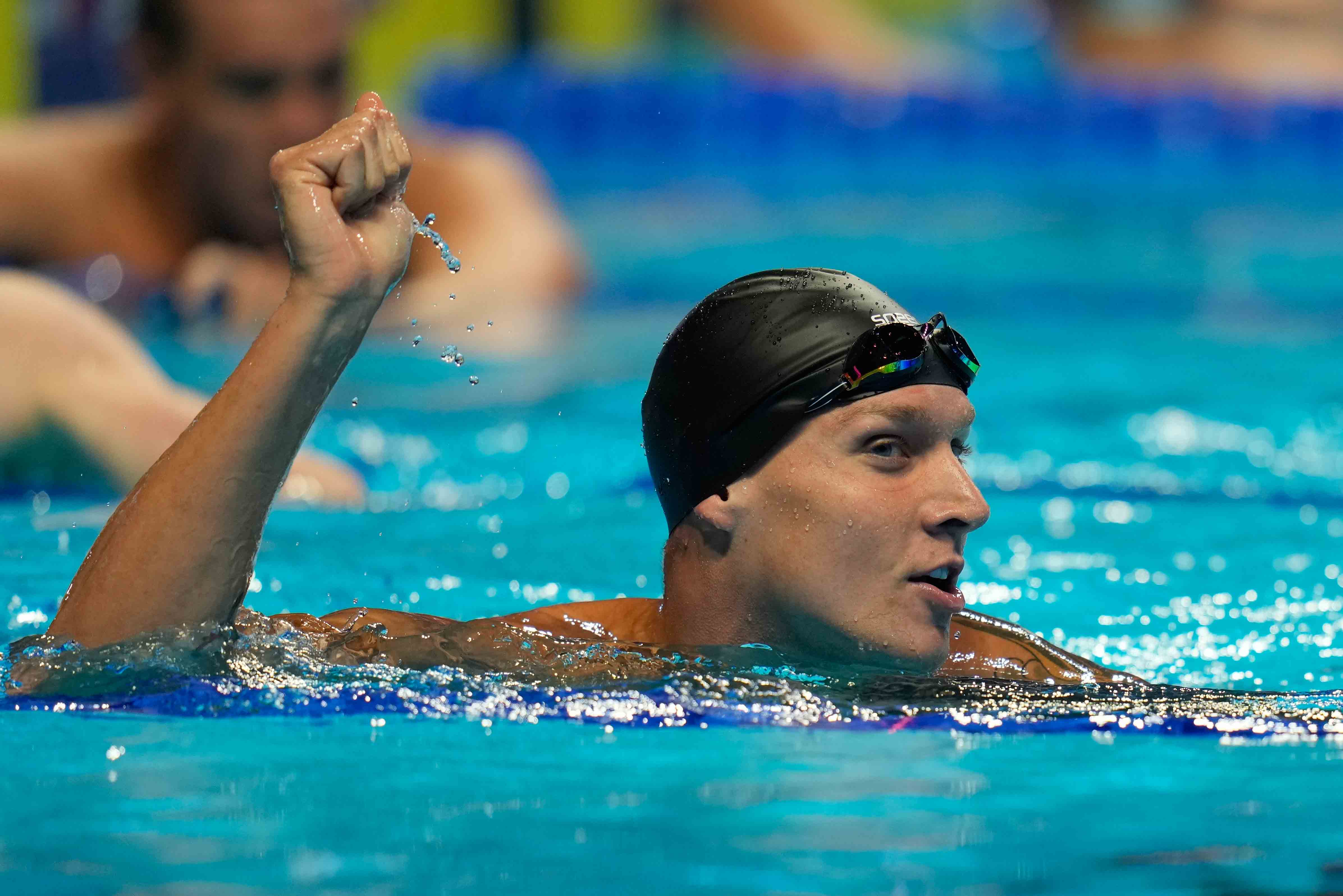 Caeleb Dressel reacts after winning the men