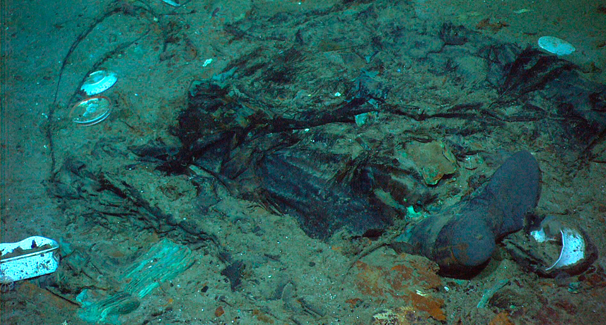 the remains of a coat and boots on the sea bed near the Titanic