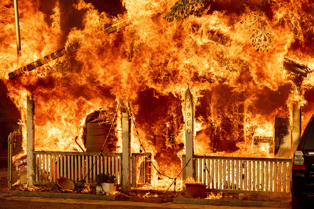 Fire consumes a home as the Sugar Fire, part of the Beckwourth Complex Fire, tears through Doyle, Calif.